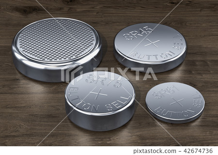 Button cells on the wooden table, 3D rendering Button cells on the wooden table, 3D rendering 42674736