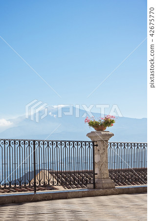 Aerial view of city roofs with Etna volcano 42675770