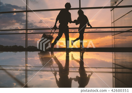 Cheerful girl holding glad male arm 42680351