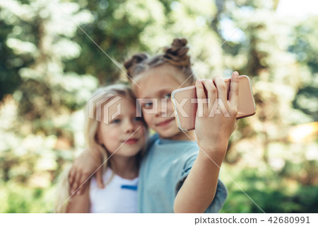 Happy children making photos with mobile 42680991