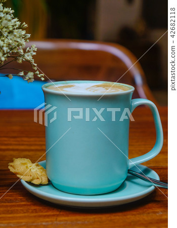 Blue cup of coffee on wooden table Blue cup of coffee on wooden table 42682118