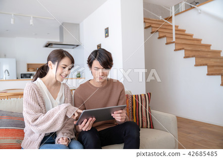 A couple looking at a tablet A couple looking at a tablet 42685485