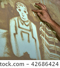 Artist paints sand 42686424