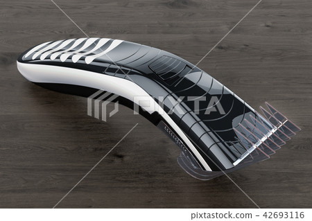 Electric hair clipper or trimmer on the table Electric hair clipper or trimmer on the table 42693116