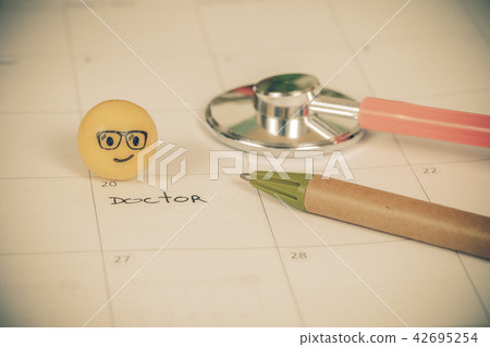 The words Doctor written on a Calendar to Remind The words Doctor written on a Calendar to Remind 42695254