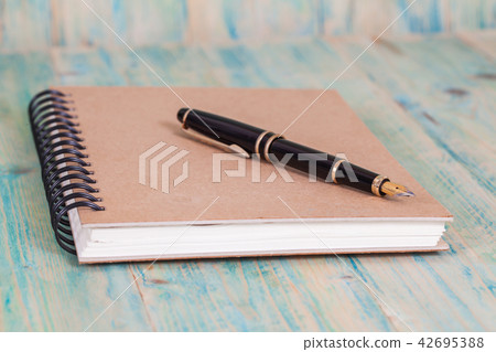 Diary with pen on wood background Diary with pen on wood background 42695388