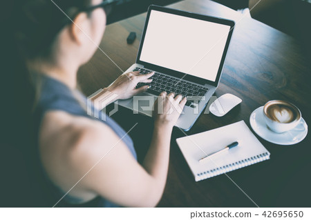 young women working and used computer young women working and used computer 42695650