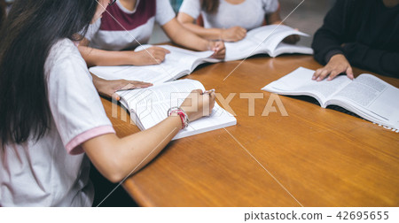 young people being reading books together in the library. educat young people being reading books together in the library. educat 42695655