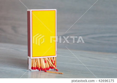 Matchstick on color wood table. 42696175