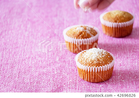 Muffins with coconut powder. Pink background Muffins with coconut powder. Pink background 42696826