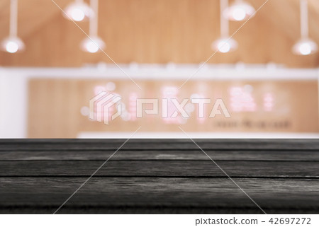 Empty wooden table and blurred background of abstract in front o 42697272