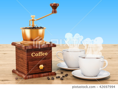 Manual coffee grinder with cup of coffee 42697994