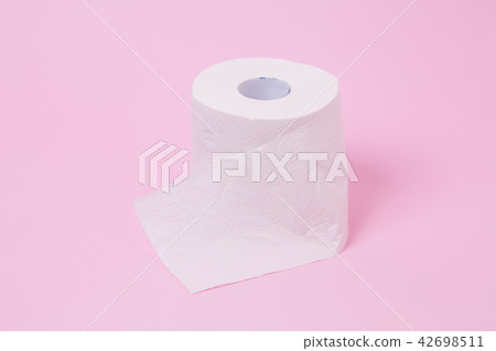 The roll of white toilet tissue paper on pink back 42698511