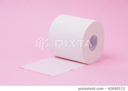 The roll of white toilet tissue paper on pink back The roll of white toilet tissue paper on pink back 42698513