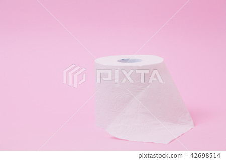 The roll of white toilet tissue paper on pink back The roll of white toilet tissue paper on pink back 42698514