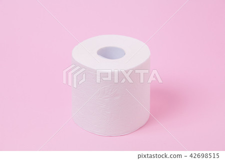 The roll of white toilet tissue paper on pink back 42698515