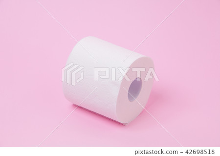 The roll of white toilet tissue paper on pink back The roll of white toilet tissue paper on pink back 42698518