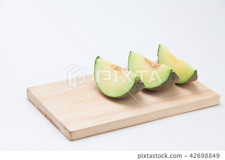 Cantaloupe melon sliced on chopping board Cantaloupe melon sliced on chopping board 42698849