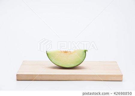 Cantaloupe melon sliced on chopping board Cantaloupe melon sliced on chopping board 42698850