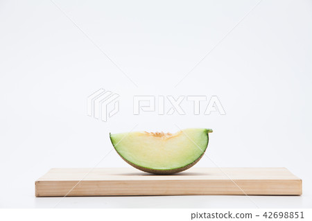 Cantaloupe melon sliced on chopping board Cantaloupe melon sliced on chopping board 42698851
