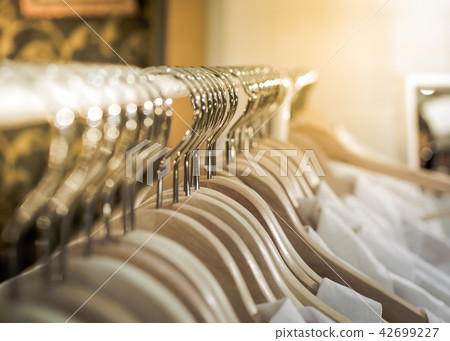 Group of silver clothes hangers.  42699227