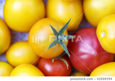 yellow and red tomatoes as background 42699394