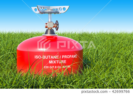Red primus stove on the green grass 42699766