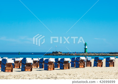 Beach and mole with blue sky in Warnemuende Beach and mole with blue sky in Warnemuende 42699899