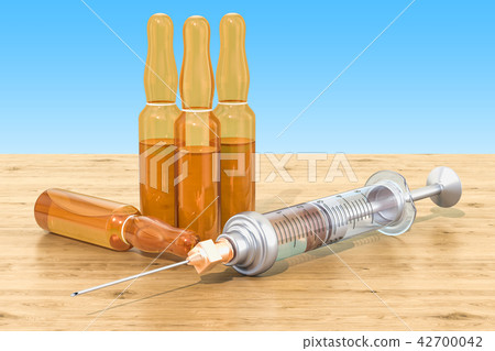 Syringe and ampules on the wooden table Syringe and ampules on the wooden table 42700042
