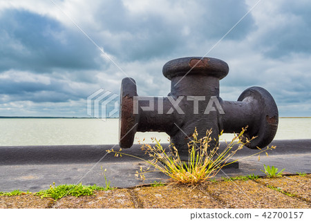 Port with bollard and clouds in Born, Germany Port with bollard and clouds in Born, Germany 42700157