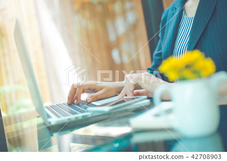 Business woman working with laptop in office. Business woman working with laptop in office. 42708903