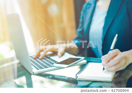 Businesswoman is taking notes on a pen. Businesswoman is taking notes on a pen. 42708904