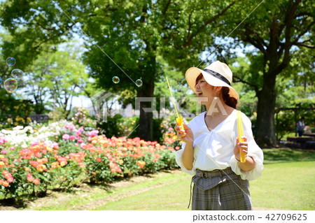 A woman blowing a bubble ball A woman blowing a bubble ball 42709625