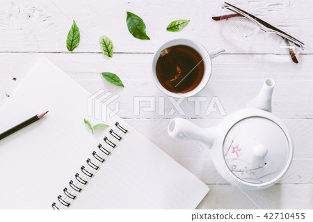 Cup of tea with book on wooden table Cup of tea with book on wooden table 42710455