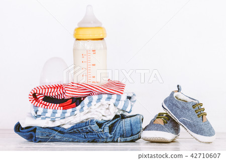 Children clothing and bottle with milk on wooden 42710607