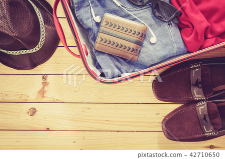 Men's casual  in suitcase on wooden table 42710650