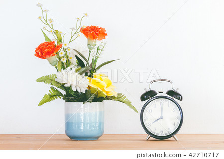 Still life with flowers on wooden table 42710717