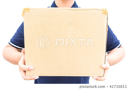 Delivery man in blue uniform holding box isolated 42710811