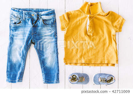 Children clothing  on wooden background 42711009