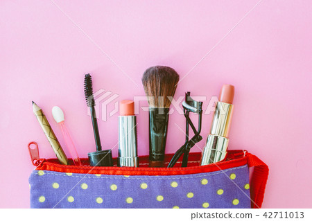 Make up bag with cosmetics on pink background 42711013