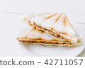 Sandwich on wooden table 42711057