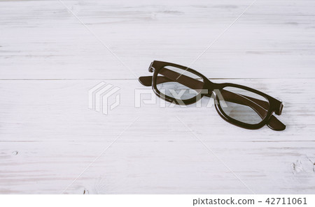 Fashion sunglasses on wooden table 42711061
