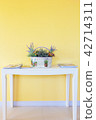 white basket on white table with yellow wall 42714311