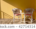 the empty chairs on yellow background with sunligh 42714314