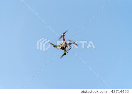 Drone with camera on blue sky. 42714463