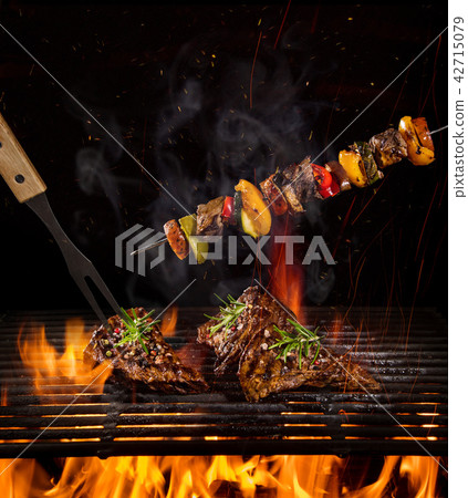 Beef steaks on the grill with flames Beef steaks on the grill with flames 42715079