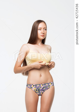 Woman in underwear crumpling top 42715436