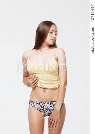 Woman in underwear crumpling top Woman in underwear crumpling top 42715437