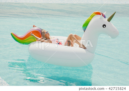 Enjoying suntan Woman in bikini in the swimming pool. Summer Vacation Enjoying suntan Woman in bikini in the swimming pool. Summer Vacation 42715824