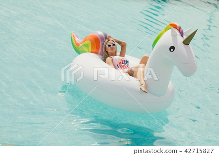 Enjoying suntan Woman in bikini in the swimming pool. Summer Vacation Enjoying suntan Woman in bikini in the swimming pool. Summer Vacation 42715827